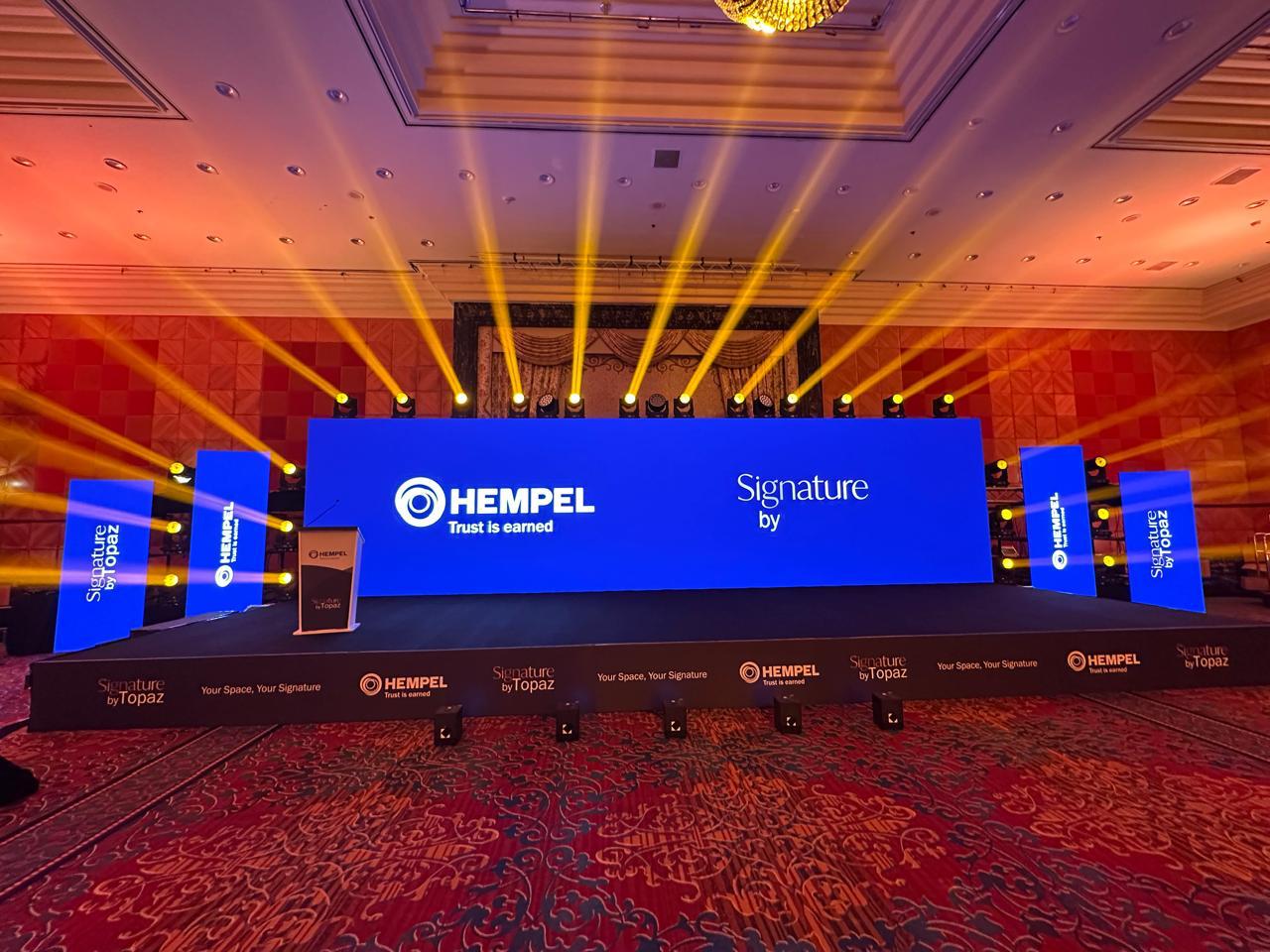 Hempel Signature by Topaz launch stage with branded LED screens.